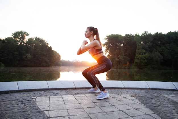 Dziewczynka sport fitness moda sportowa robi ćwiczenia fitness na ulicy, sporty na świeżym powietrzu, miejski styl