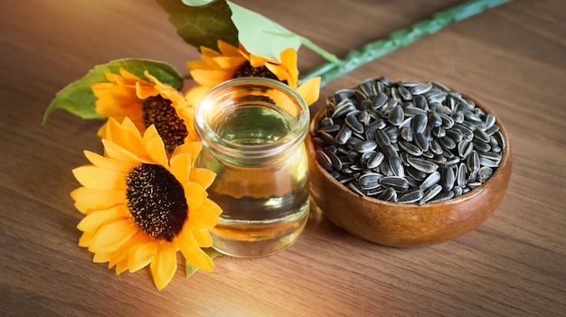 Zdjęcie ekologiczne nasiona słonecznika i olej słonecznikowy na drewnianym stole