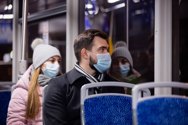 Facet i dziewczyna w maskach jeżdżą nocą tramwajem