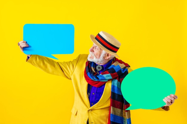 Fajny starszy mężczyzna z modnym portretem w stylu odzieży na kolorowym tle