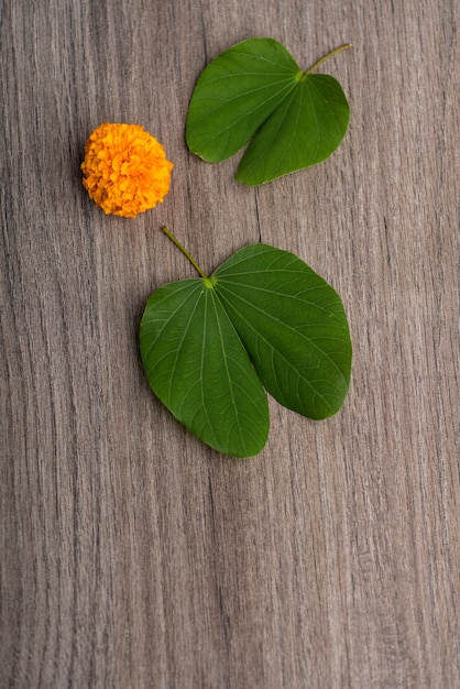 Festiwal Indian Dasera, Pokazując Złoty Liść (bauhinia Racemosa) I Kwiaty Nagietka Na Drewnianym Stole.