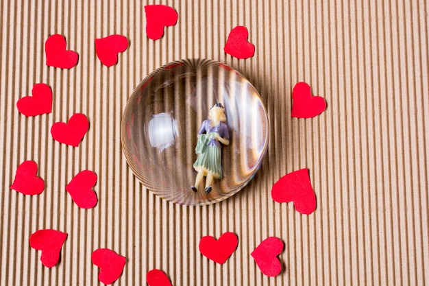 Figurka kobiety i koncepcja miłości z czerwonymi papierowymi sercami