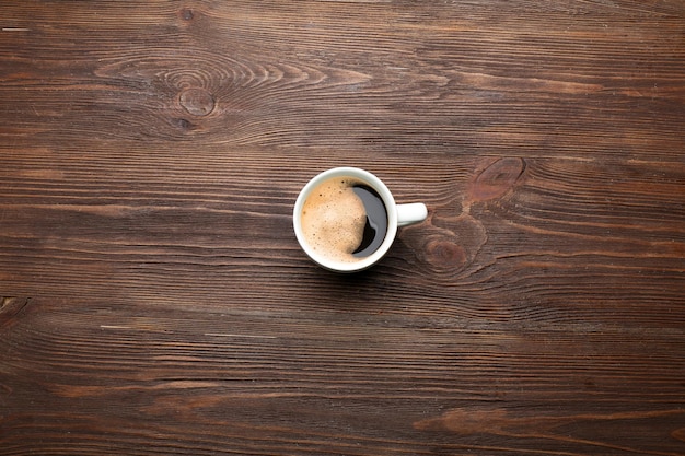 Filiżanka kawy na drewnianym stole z widokiem