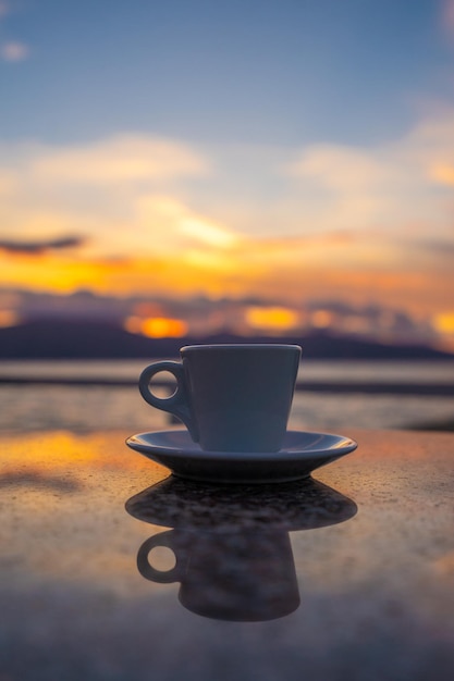 filiżanka kawy na stole nad niebieskim niebem i morzem koncepcja letnich wakacji