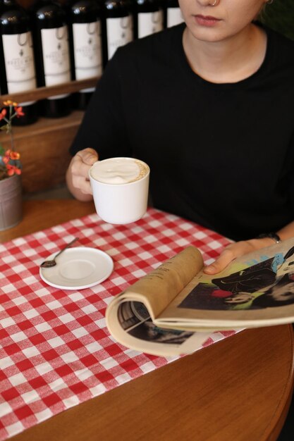 Filiżanka kawy podczas czytania książki lub czasopisma
