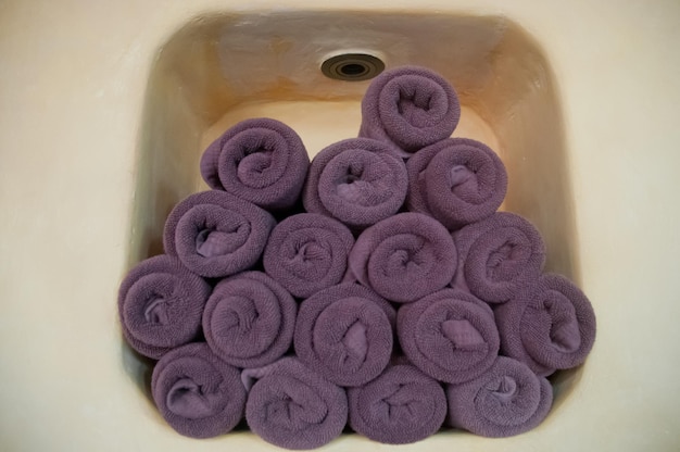 Zdjęcie fioletowy ręcznik w rolkach w ścianie szafy