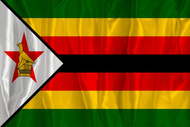 Flaga Zimbabwe na jedwabnym tle to wielki symbol narodowy Tekstura tkanin Oficjalny państwowy symbol kraju