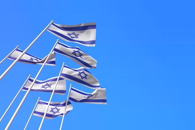 Flagi Izraela powiewają na wietrze na tle błękitnego nieba