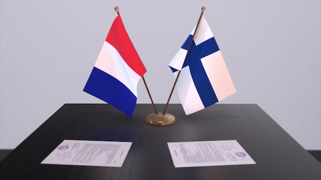 Flagi narodowe Finlandii i Francji na stole w sali konferencyjnej dyplomatycznej Umowa dotycząca polityki