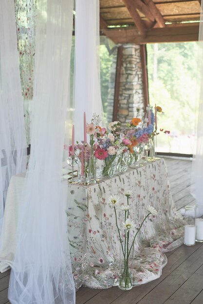 Florystyka Kwiatowa dekoracja ślubu w pastelowych kolorach Wiele kwiatów w różnych wazonach i naczyniach