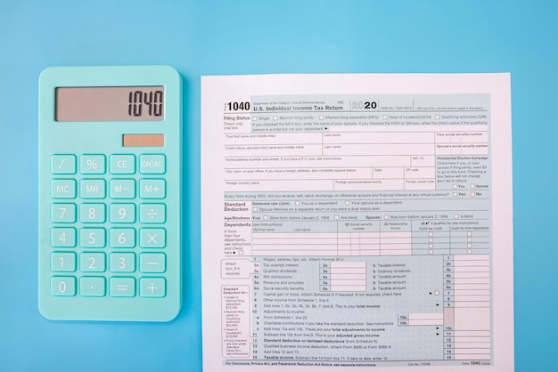 Zdjęcie formularze podatkowe 1040 i niebieski kalkulator na niebieskim tle. widok z góry.