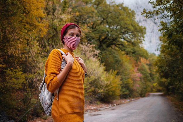 Fotografia mody plenerowej młodej pięknej damy otoczonej jesiennym lasem w górach