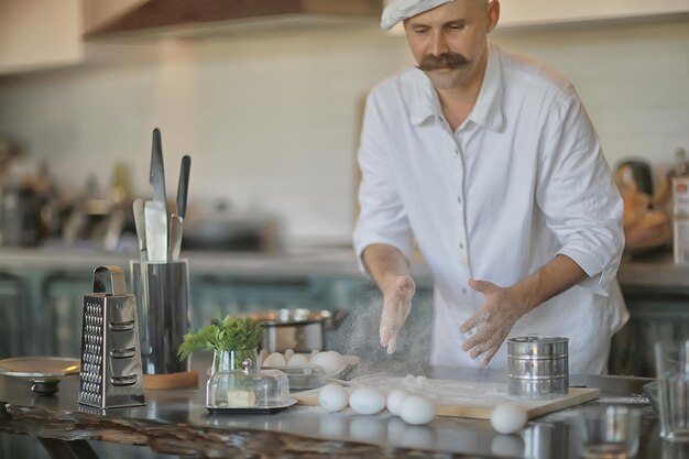 francuski szef kuchni w kuchni przygotowujący jedzenie, gotujący, haute cuisine, mężczyzna z wąsami