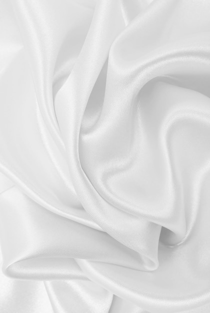 Gładka elegancka biała jedwabna lub satynowa luksusowa tekstura tkaniny jako tło ślubu
