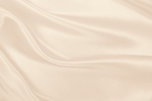 Gładka elegancka złota jedwabna lub satynowa luksusowa tekstura tkaniny jako tło weselne w odcieniach sepii