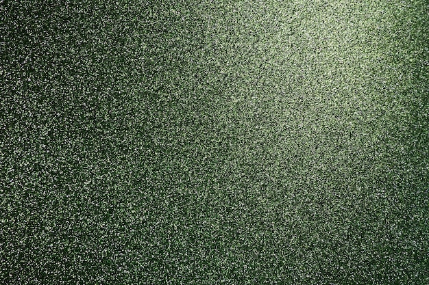 Głęboka trawiasta zieleń Tekstura szorstkiego papieru lub tektury Nieostre bokeh błyszczy i błyszczy na zgięciu Świąteczne zielone tło z podświetlanym gradientem od góry po prawej