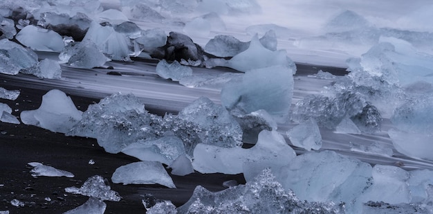 Góry lodowe nad diamentową plażą, jedwabna woda o długiej ekspozycji