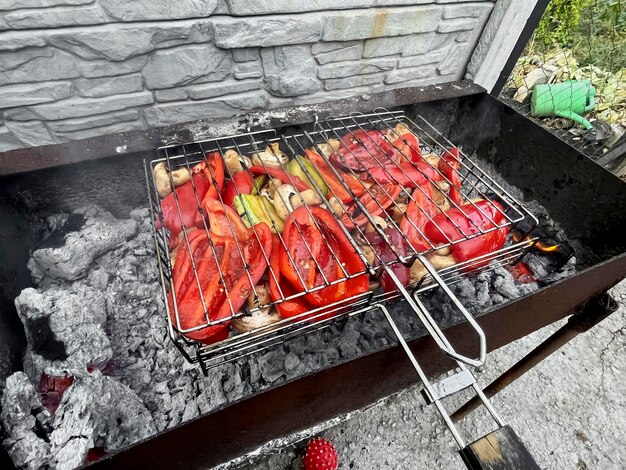 Zdjęcie grill warzywny papryka i grzyby smażone na grillu pieczarki papryka cukinia pieczona na podwórku na ogniu