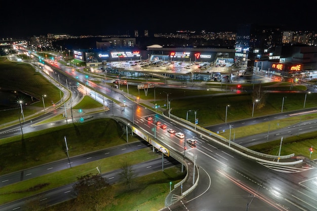 Grodno Białoruś Czerwiec 2021 Widok z góry na główny węzeł drogowy w mieście nocą Ruch samochodów w nocnym mieście Światło z pojazdów i latarni na drogach i ulicach