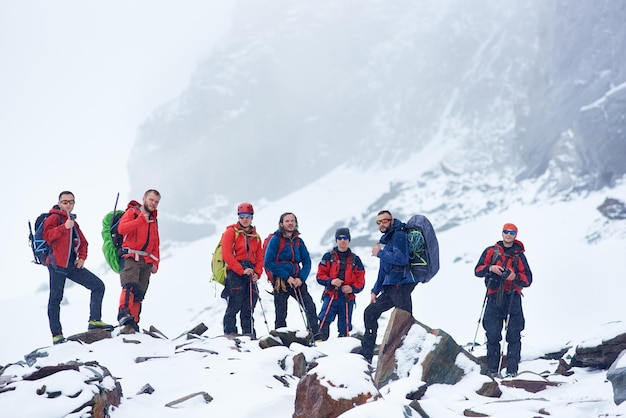 Grupa alpinistów stojących na skalistym wzgórzu