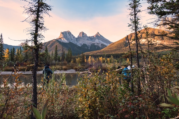 Grupa Fotografów Robiących Zdjęcie W Three Sisters Mountains To Skaliste Góry W Jesiennym Lesie W Canmore, Park Narodowy Banff, Kanada