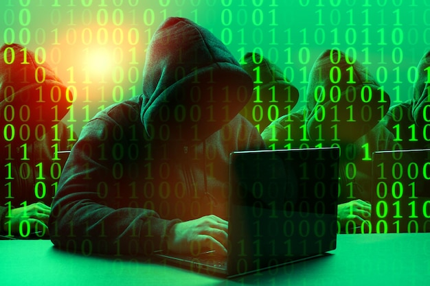Grupa hakerów Niebezpieczna zakapturzona grupa hakerów Internetowa cyberprzestępczość Cyber atak łamanie systemu i koncepcja złośliwego oprogramowania Ciemna twarz Cyfrowy kod binarny na tle