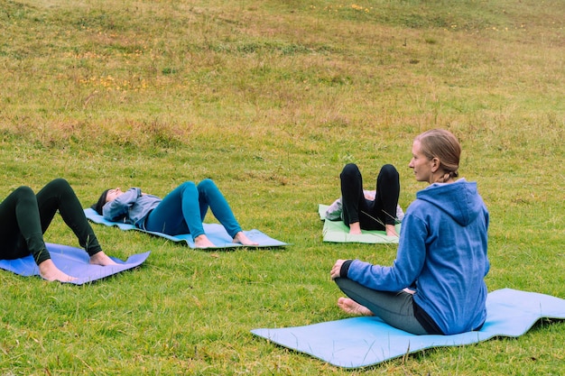 Grupa kobiet uprawiających jogę w parku. Zdrowie psychiczne.