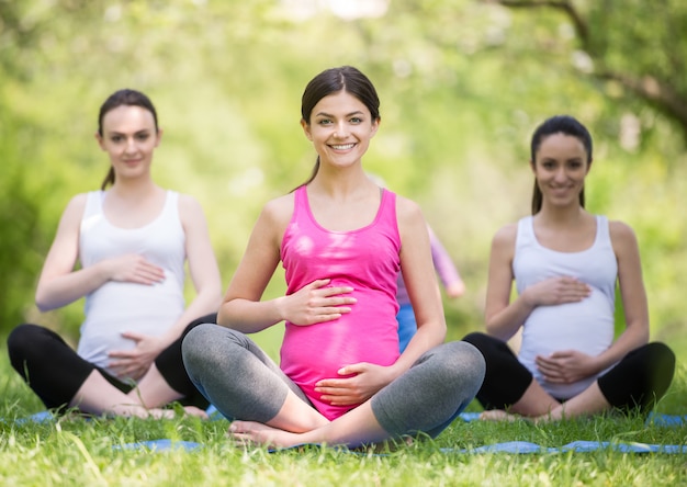 Grupa Uśmiechniętych Kobiet W Ciąży Robi Joga Prenatalna.