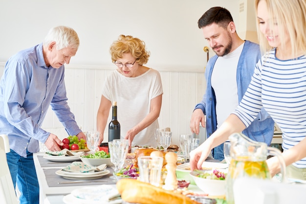 Happy Family Setting Dinner Table