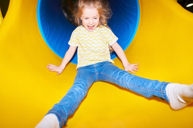 Happy Girl Going Down Slide