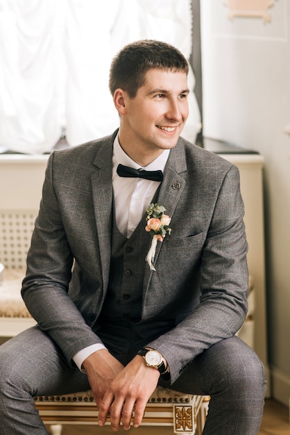 Zdjęcie happy groom portret młodego mężczyzny. pan młody przygotowuje się w pokoju na dzień ślubu.