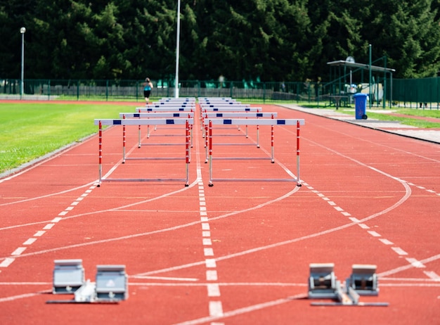 Hurdle Na Pasie Sprintowym Z Blokami Startowymi Na Niewyraźnym Tle Dwa Tory Treningowe Z Przeszkodami