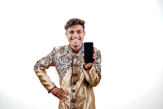 Indianin w stroju etnicznym pokazujący ekran mobilny Odosobnione tło