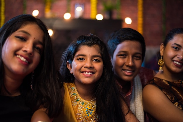 Indyjskie dzieci świętujące Diwali, Deepawali, Bhai Dooj lub Rakhi lub Raksha Bandhan z rangoli, prezentami, diya