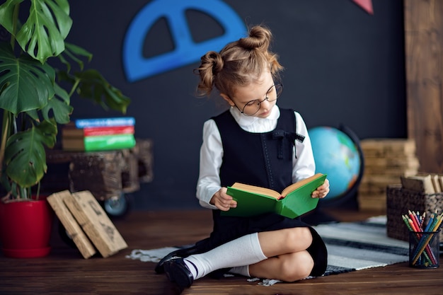 Inteligentna dziewczyna czytanie podręcznika w szkole