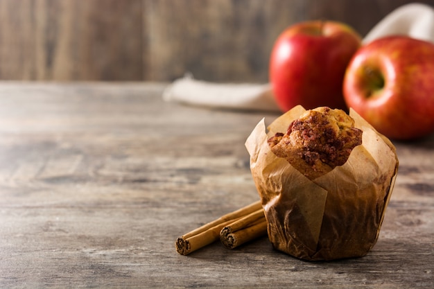 Jabłka i cynamonowy słodka bułeczka na drewnianym stole. Skopiuj miejsce