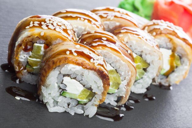 Japońska restauracja, sushi roll na czarnej tabliczce z łupków.