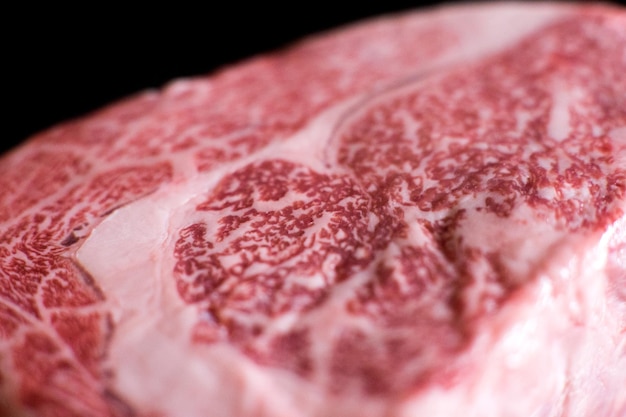 Japońska wołowina Wagyu. Produkt mięsny premium na czarnym tle.