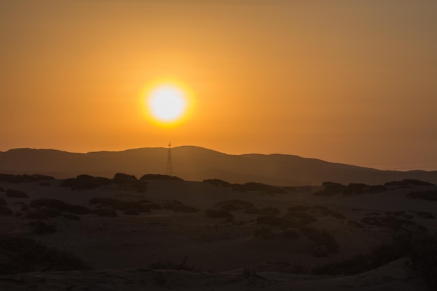 Zdjęcie jasne, świecące słońce z górami na pustyni egipskiej