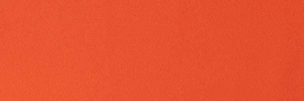 Jednokolorowa jasnopomarańczowa tkanina jako tło blisko pomarańczowej tkaniny