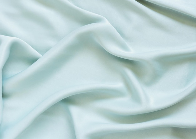 Jedwabna drapowana miętowa tkanina z zakładkami i brokatem Teksturowane tło w delikatnym zielonym kolorze