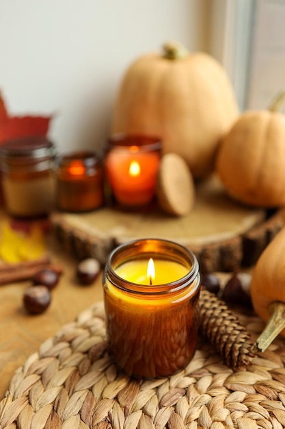 Jesienna martwa natura na parapecie płonąca świeca dynie i świece
