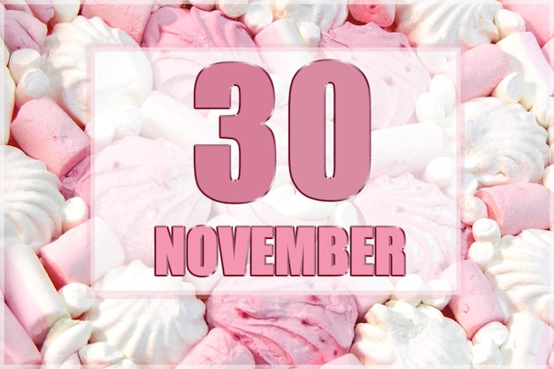 Kalendarzowa data na tle biało-różowych pianek 30 listopada to trzydziesty dzień miesiąca