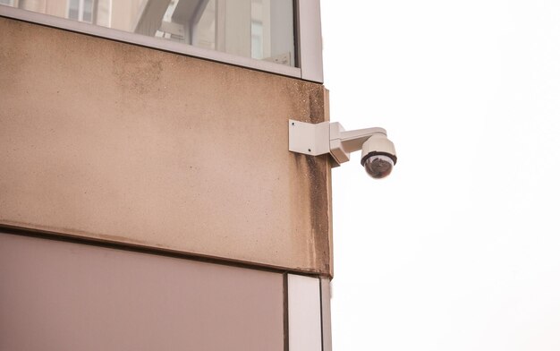 Kamera bezpieczeństwa zamontowana na budynku z widokiem na ruchliwą ulicę, a kamera przydrożna na słupku