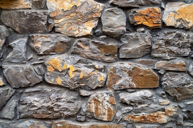 Kamienna ściana Zbliżenie ściana z dzikiego kamienia Kamienne tło