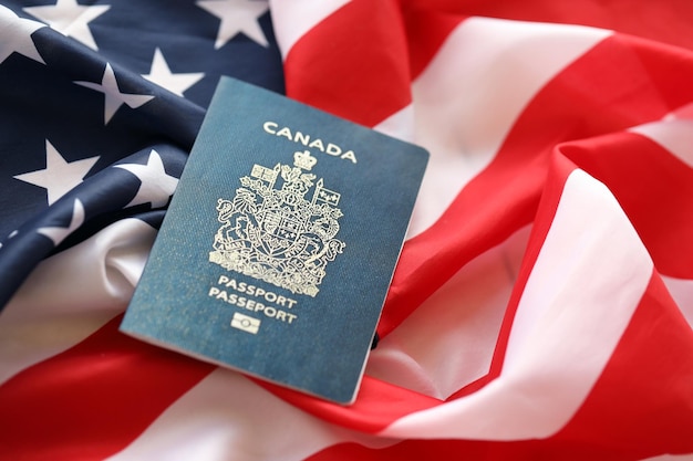 Kanadyjski paszport na amerykańskiej fladze krajowej tło zbliżenie turystyka i dyplomacja koncepcja