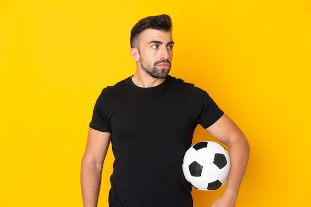Kaukaski Mężczyzna Na Białym Tle żółty Z Piłką Nożną