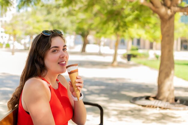 Kaukaskie kobiety jedzące lody w rożku w parku