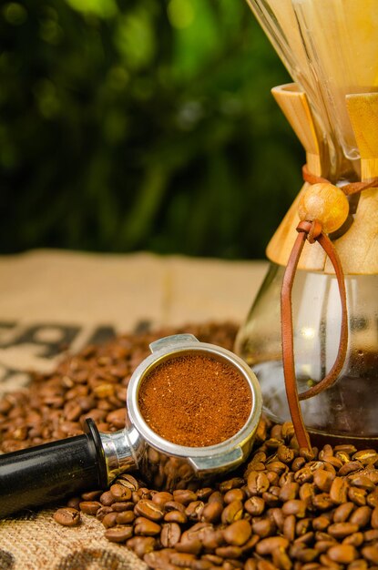 Zdjęcie kawa mielona na ziarnach kawy na stole z naturalnym tłem