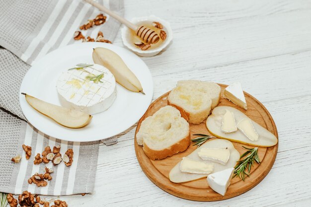 Kawałki dojrzałej gruszki z serem Camembert z grzankami na stole